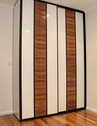 Built in Wardrobe with woven timber sliding doors