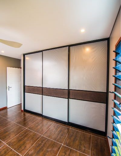 Cupboard Sliding Doors with Mesh panels and crocodile wallpaper