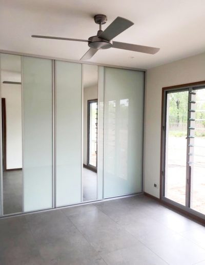Floor to ceiling white glass and feature mirror wardrobe sliding doors