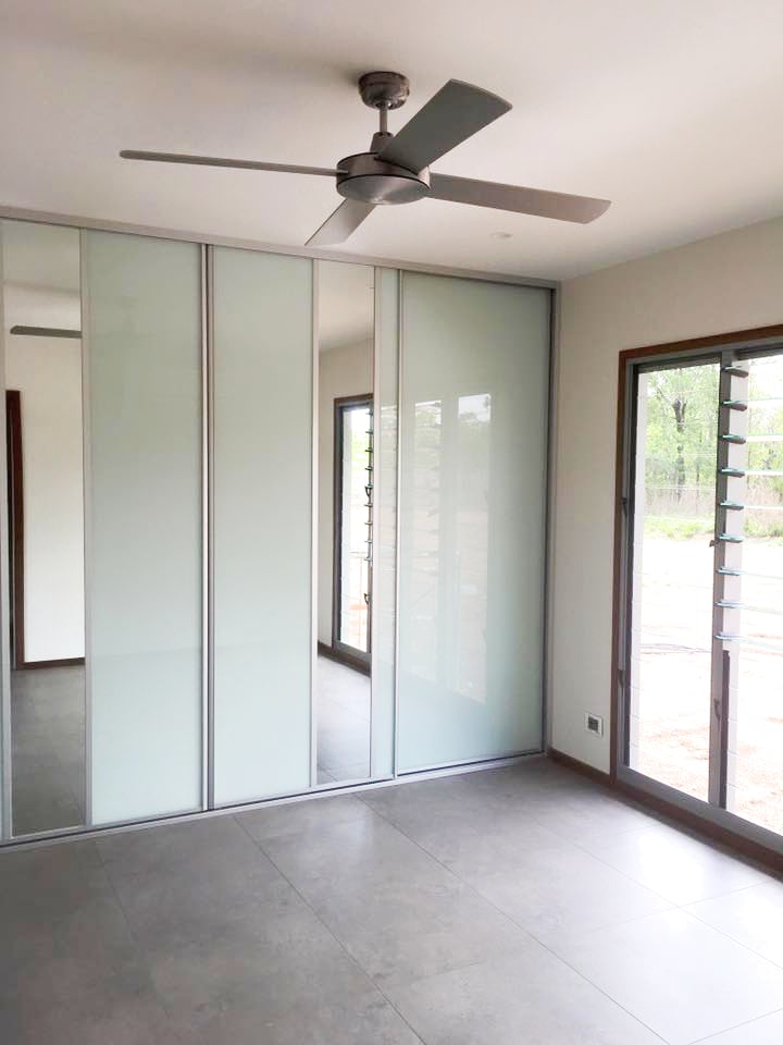 Floor to ceiling white glass and feature mirror wardrobe sliding doors