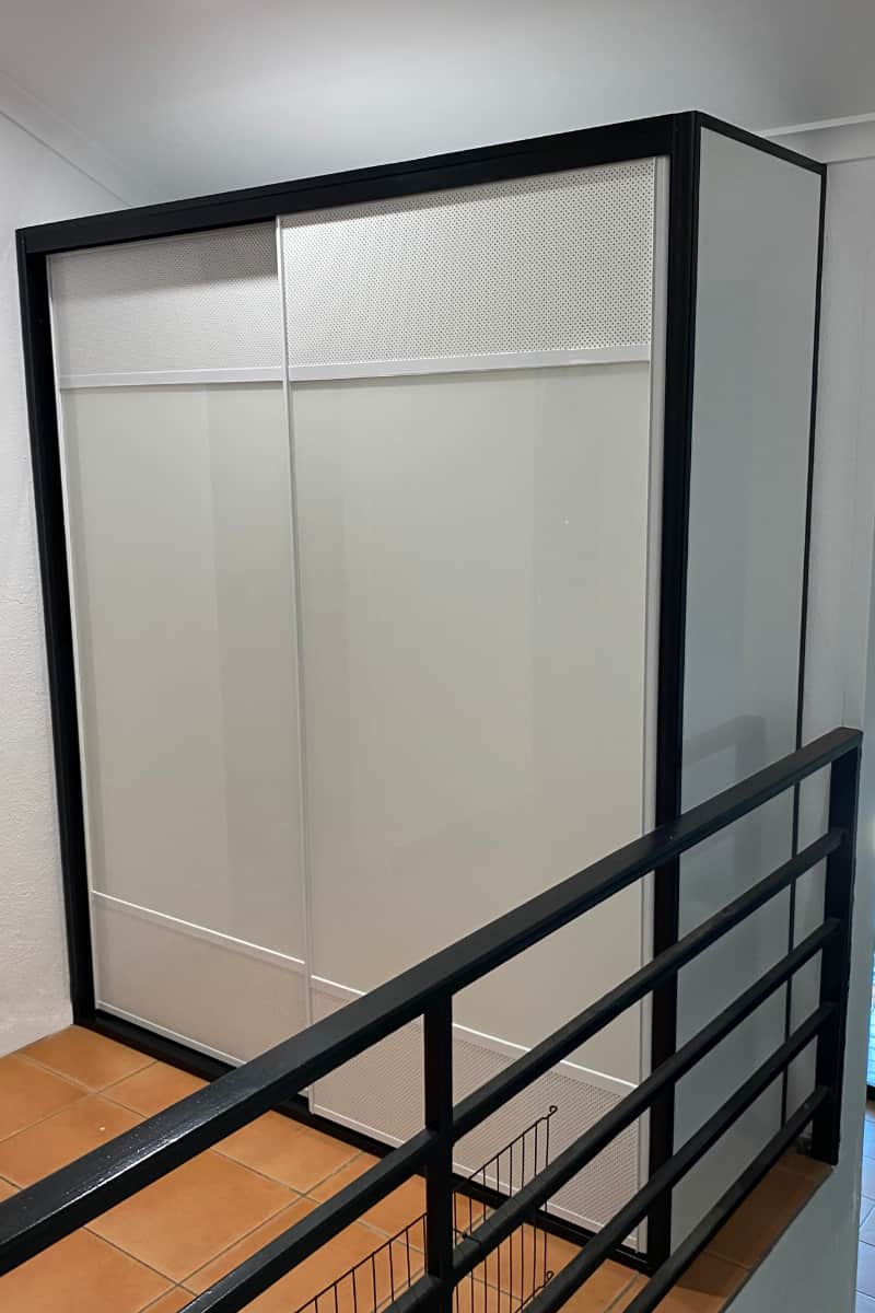 Ventilated White Linen Cupboard Doors. Powder-coated white mesh panels, white glass panels and black frames